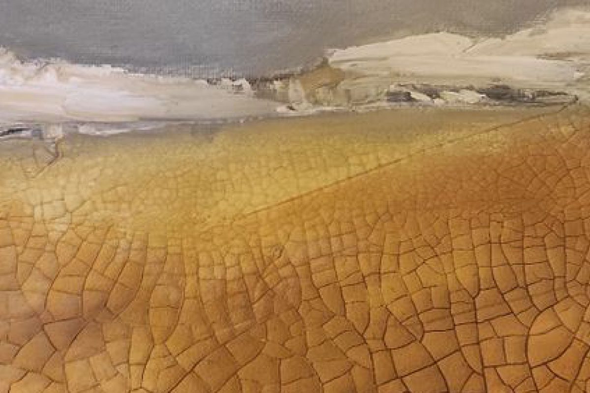 A close-up of a textured painting from Greenway Lane Art Studio with cracked, golden-brown earth tones at the bottom and smooth, gray and white brushstrokes at the top, resembling an abstract landscape.